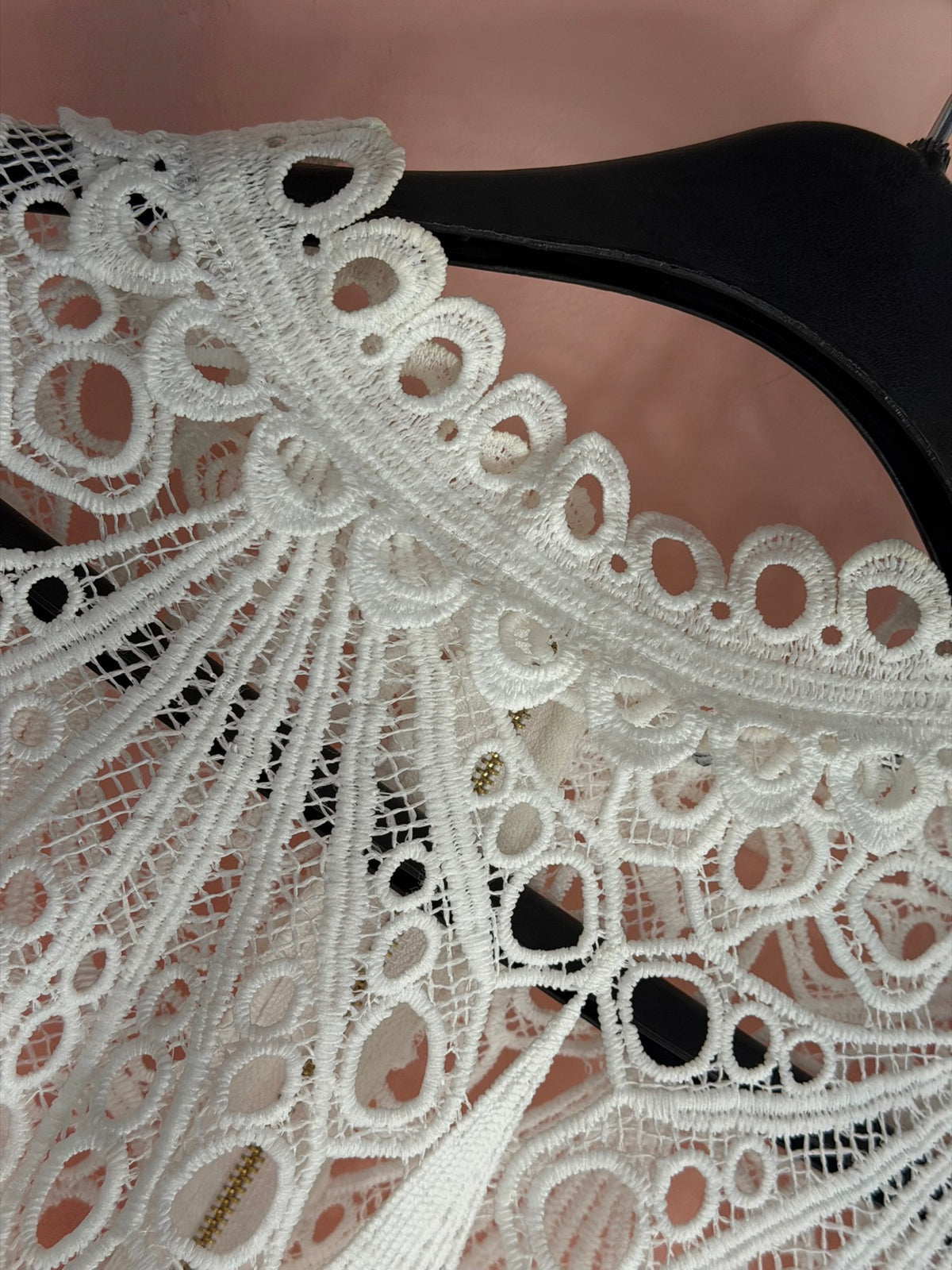 White crochet lace top, lace neckline on hanger