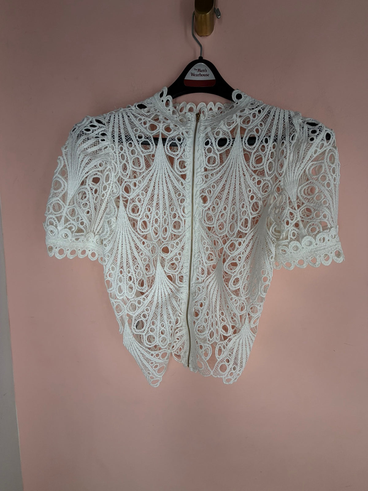 White crochet lace top, full back view on hanger