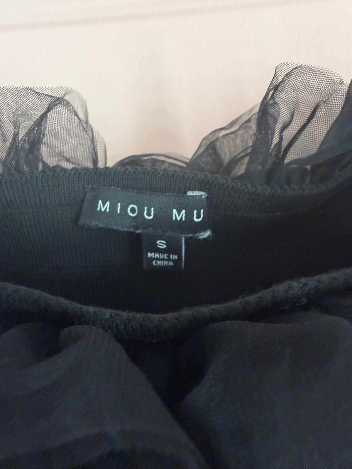 Miou Mu black tulle ruffle crop top label showing size S, made in China