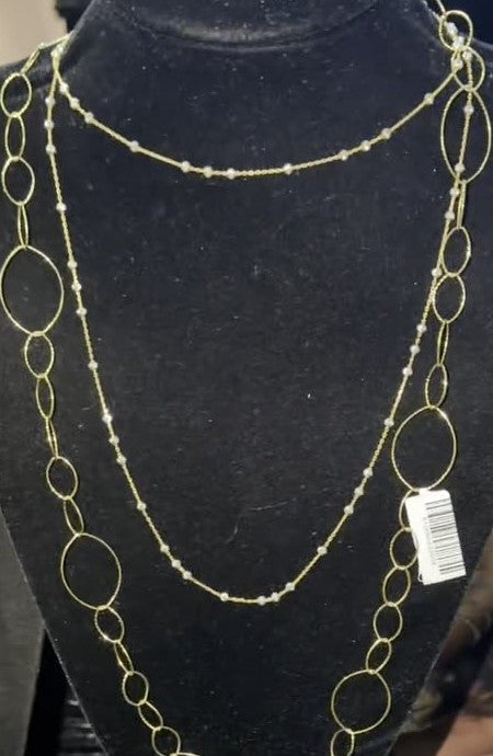 DESMOS beaded station necklace in 18k gold-plated sterling silver, photographed in the DESMOS case at Regul Silver