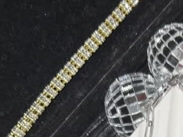 DESMOS baguette tennis necklace in 18k gold-plated sterling silver, photographed in the DESMOS case at Regul Silver