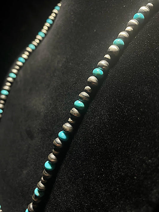 Navajo pearl necklace with turquoise — oxidized silver beads and blue turquoise beads in close view on black