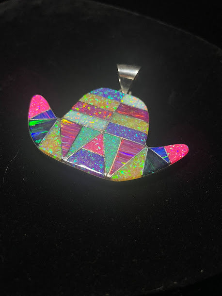 Opalite cowboy hat pendant — angled front view of the multicolor opalite mosaic, silver bail, on black