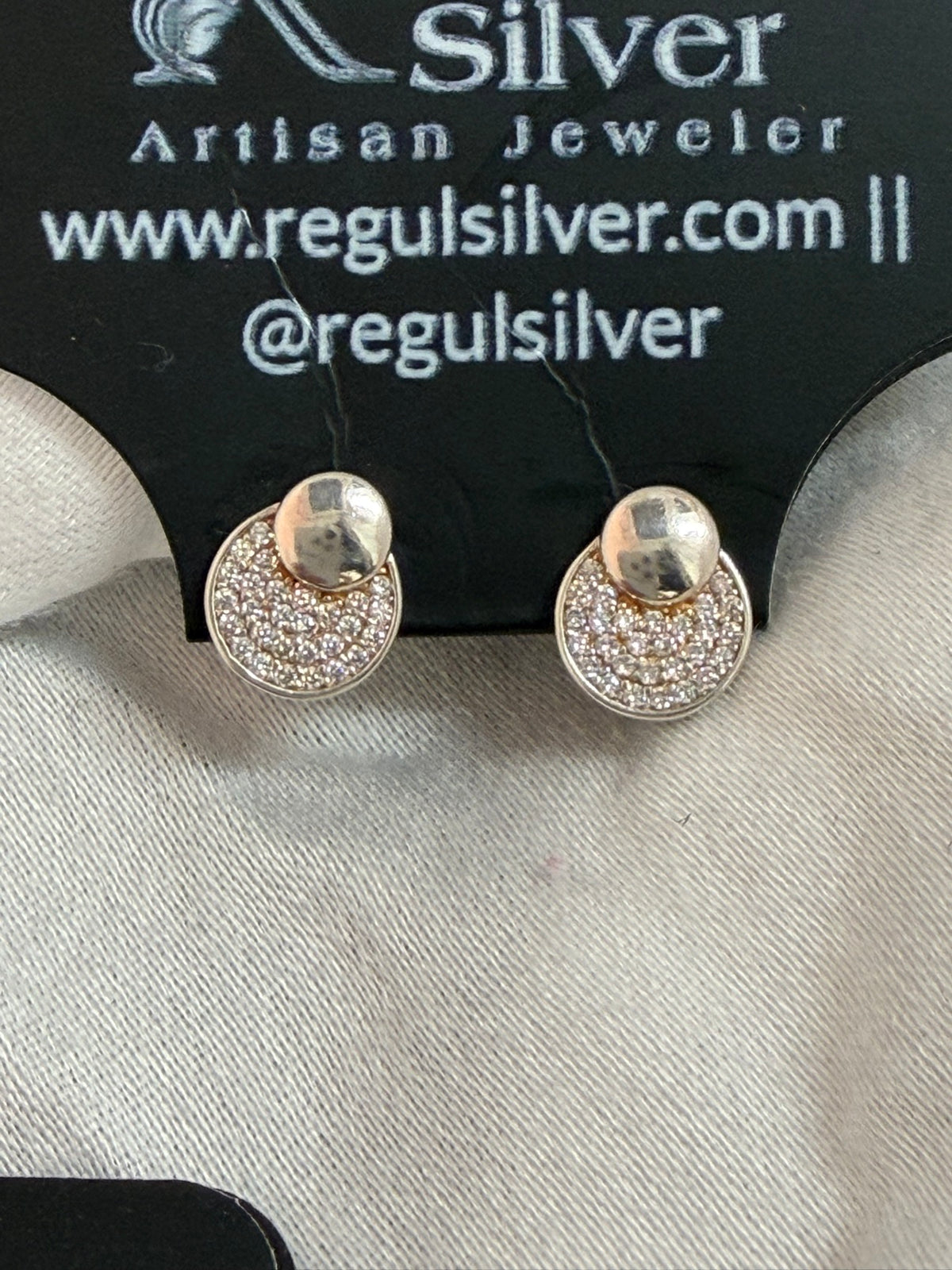 Pave dome cubic zirconia stud earrings on Regul Silver display card, front view