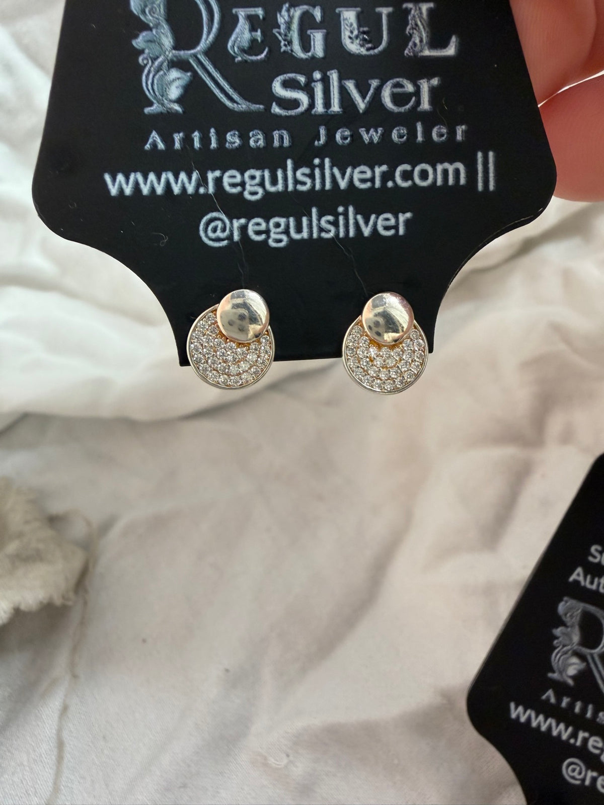 Close-up of pave dome CZ stud earrings showing sparkling pave stones and polished dome