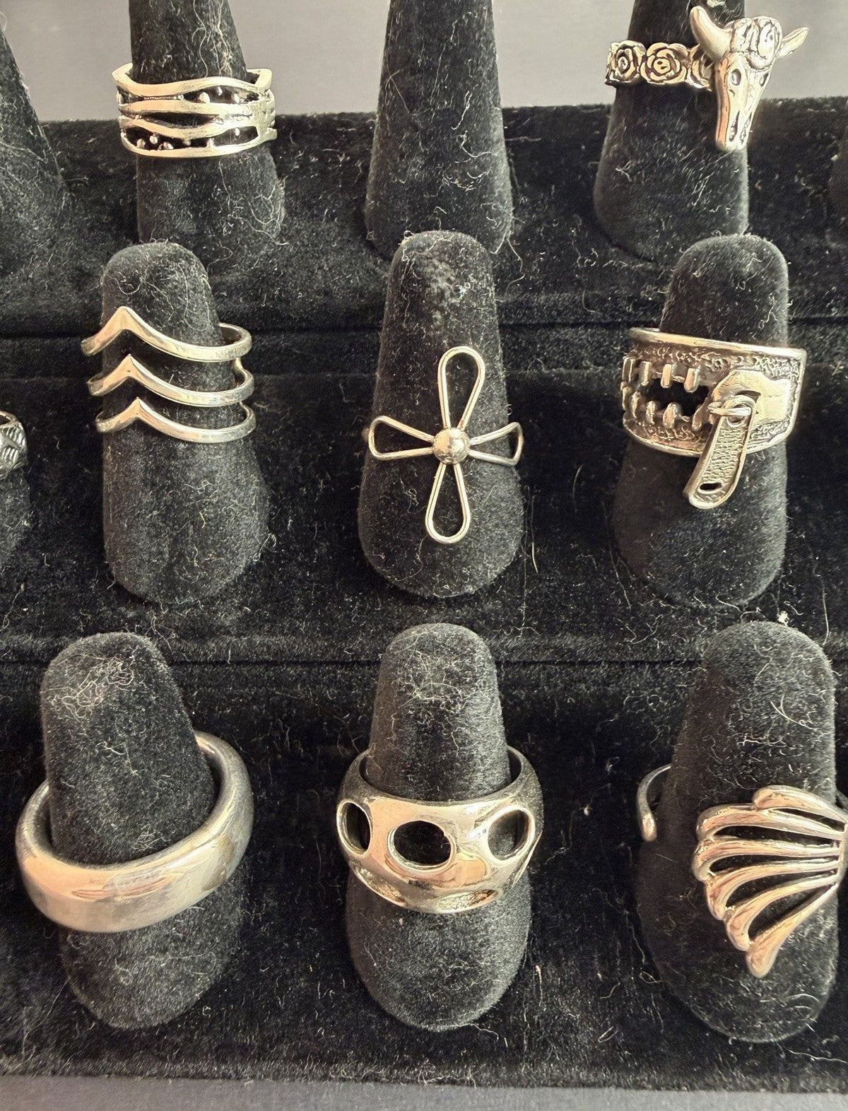 Silver rings standing on black display cones — not this listing’s chain; a gallery photo flagged in this build