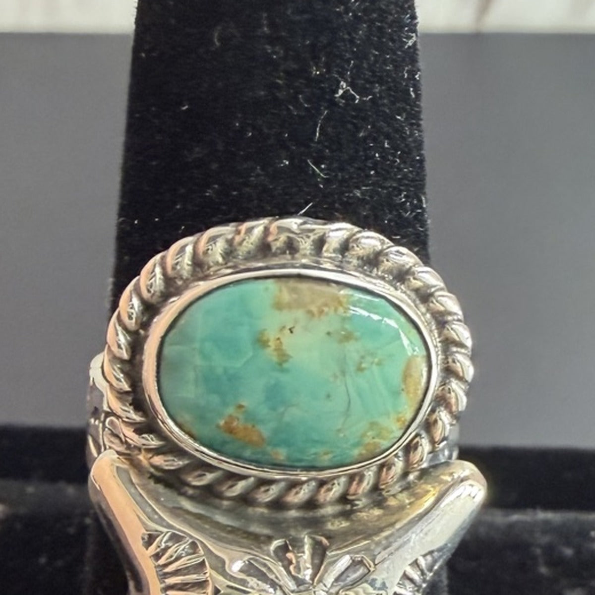 Sterling silver ring with oval turquoise stone, rope bezel, and hand-stamped star band