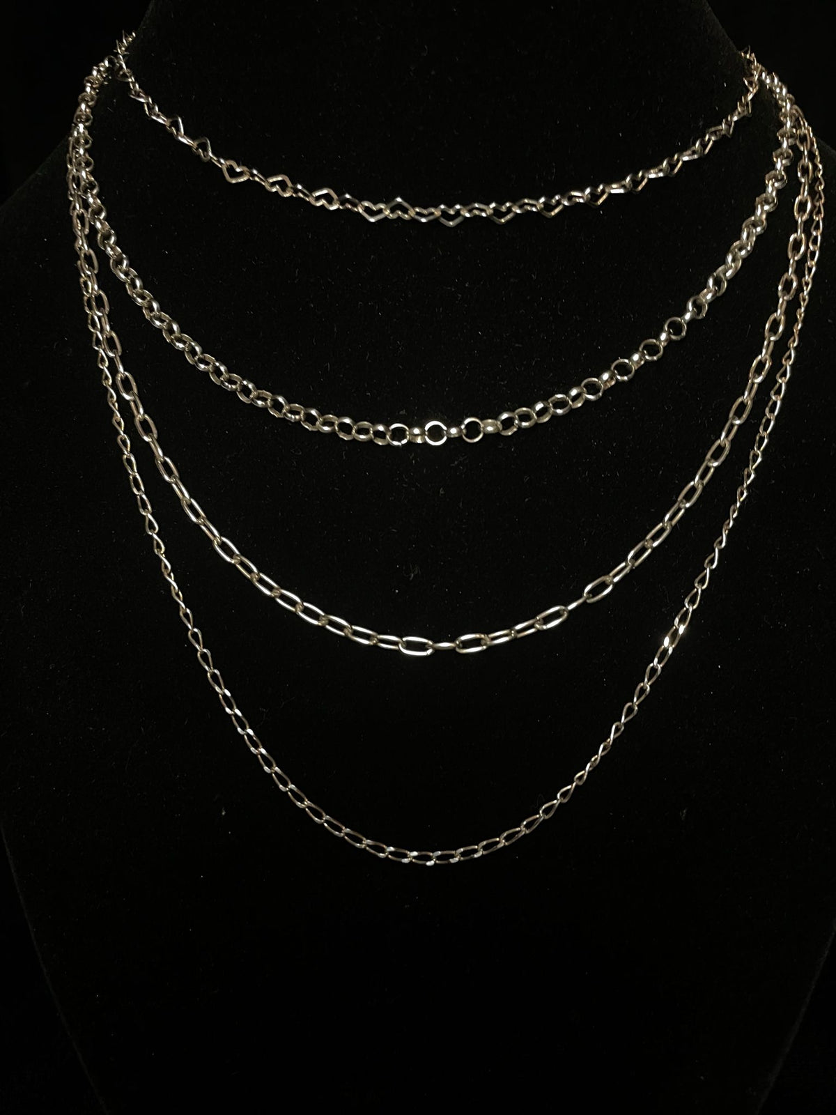 Sterling silver chain — the four styles layered on a black bust, a second view of the set