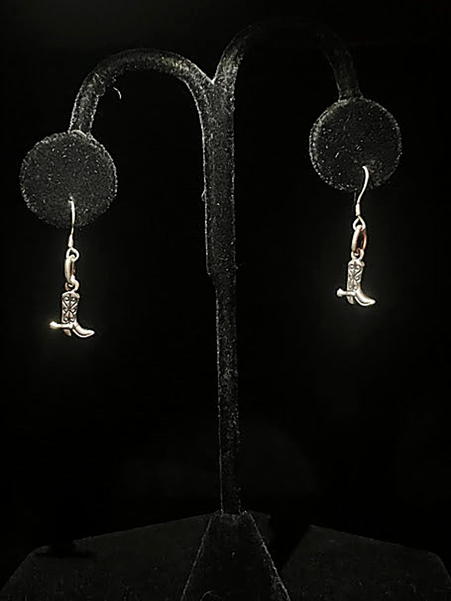 Sterling silver cowboy boot earrings - pair of tiny polished boot charms on hooks, hanging on a black stand