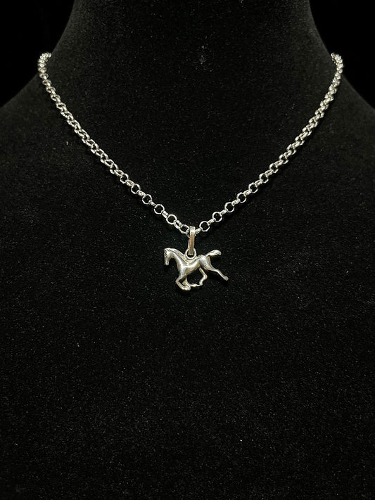 Sterling silver horse necklace — galloping horse pendant on a round-link chain, worn on a black display bust