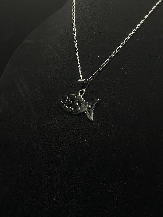Sterling silver Jesus fish pendant on a black display bust, JESUS cut through the fish, showing how the pendant wears