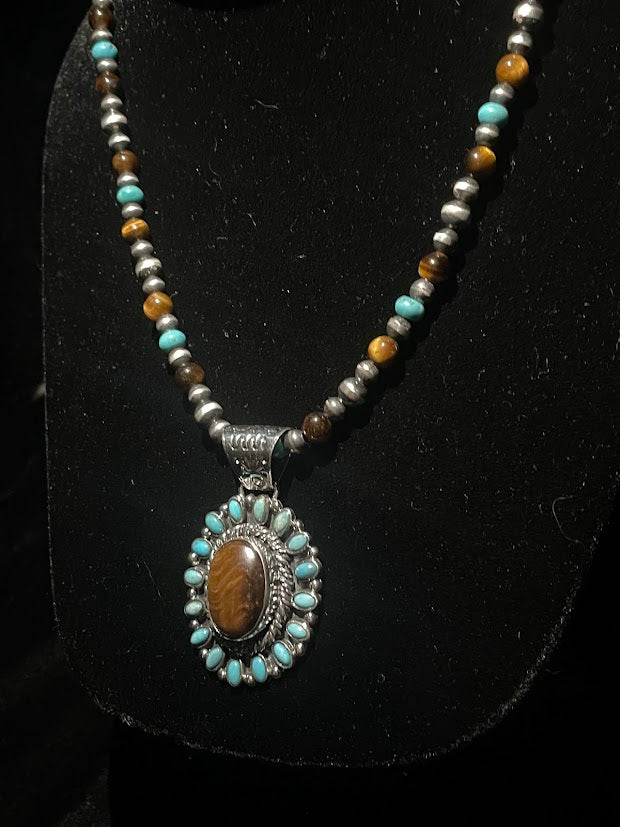 Tiger's eye turquoise necklace - the full beaded strand and pendant on a black display bust