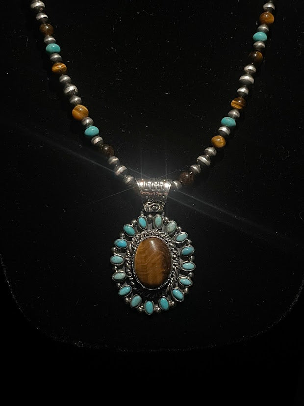 Tiger's eye turquoise necklace - oval tiger's eye pendant ringed with turquoise on a beaded strand, on black