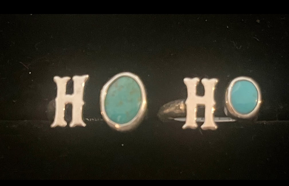 Turquoise initial ring — two letter H rings side by side, oval blue stones, close view on black