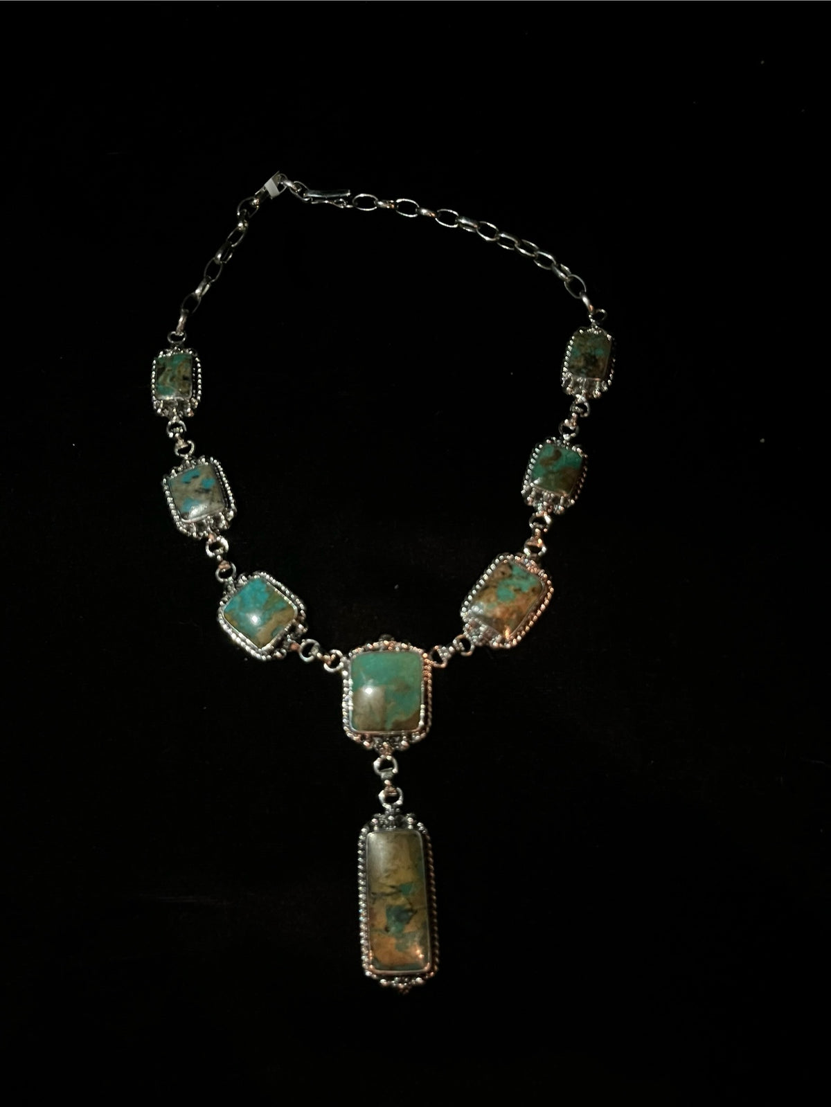 Turquoise lariat necklace — the full square-stone necklace on black, hook clasp and chain links showing