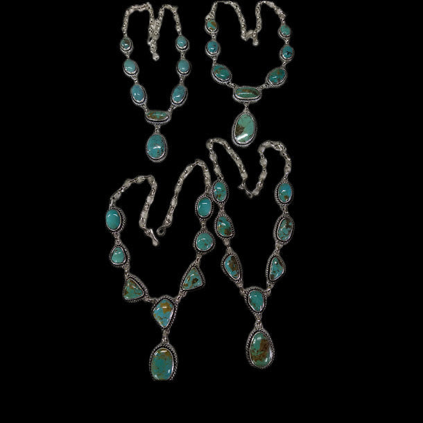 Turquoise lariat necklace gallery — four other turquoise necklaces from the studio shelf, laid out on black