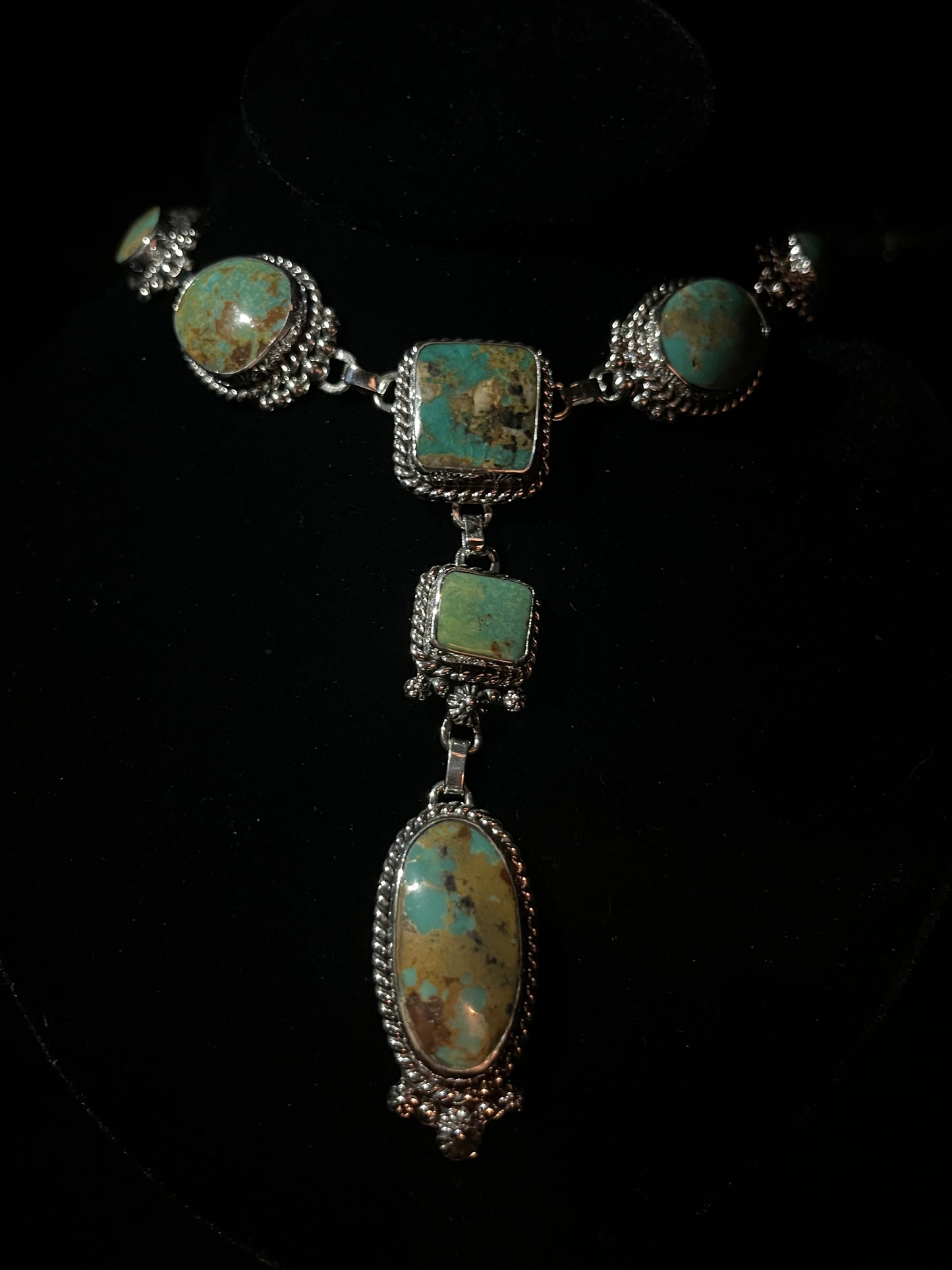 Turquoise lariat necklace — round and square turquoise stones with brown matrix in sterling silver, close view