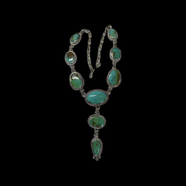 Turquoise lariat necklace — the full oval-stone necklace on black, oval stones linked in rope bezels