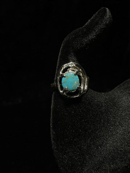 Turquoise ring — straight front view of the round Nacozari stone, prong setting in an oval silver frame