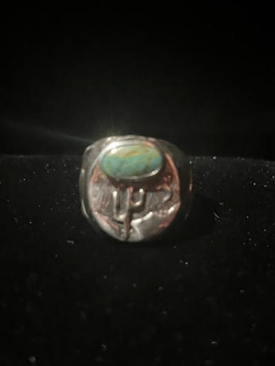 Turquoise ring — genuine Tyrone turquoise oval stone over a saguaro cactus landscape face, sterling silver, on black velvet
