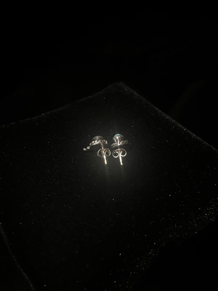 Turquoise stud earrings — backs of the mini pair on black velvet, butterfly clasps and posts showing