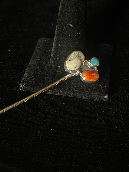 White buffalo hat pin — a three-stone pin, its white buffalo oval beside a turquoise round and a spiny oyster oval