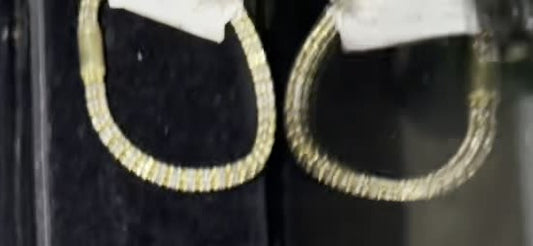 DESMOS woven hoop earrings in two-tone sterling silver, the pair hanging in the studio case at Regul Silver