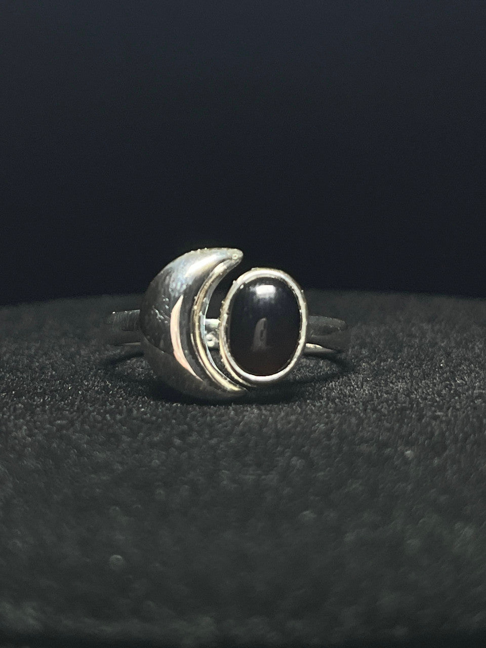 Crescent moon ring — black obsidian oval beside a polished sterling silver crescent moon on black