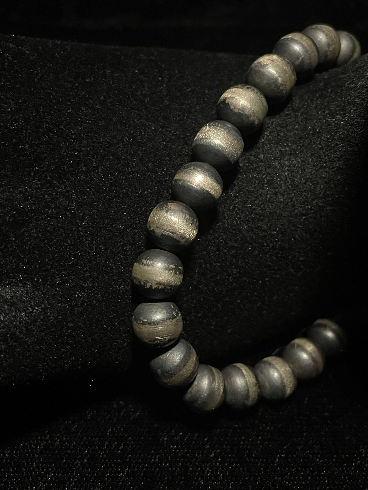Navajo pearl bracelet — close view of the dark oxidized handmade silver beads on a black display