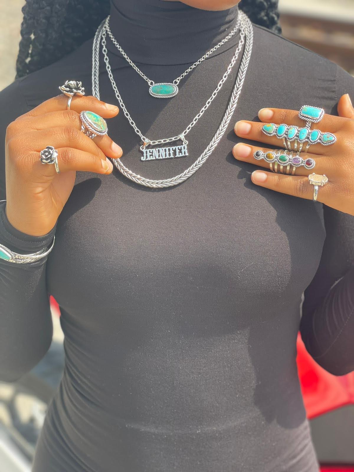 Turquoise ring — the six-stone row worn on the hand in a full sterling silver and turquoise jewelry look, outdoors