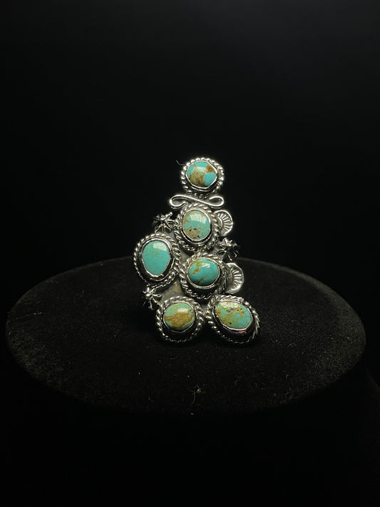 Turquoise ring — six genuine Sonoran turquoise stones in sterling silver rope bezels, front view on a black stand